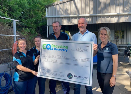 Group of people holding a large novelty cheque