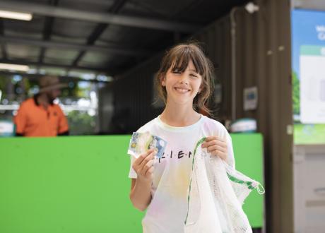 Smiling girl with recycling and money